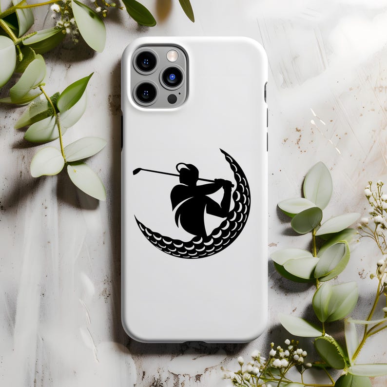 May include: White iPhone case with a black silhouette of a golfer swinging a club inside a crescent moon shape made of golf balls.