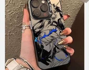 May include: A clear phone case with a black and white anime-style illustration of a character with blue accents. The case has a black border and the text "SO COOL". The phone case is held by a person with long, manicured nails.