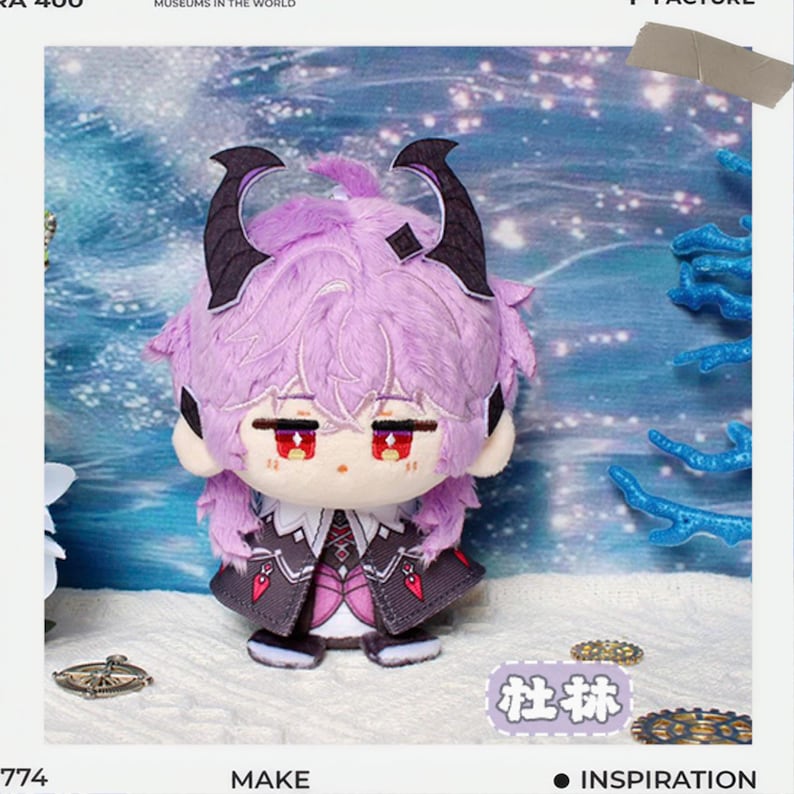 May include: A plush doll with a purple fluffy head, black horns, and red eyes. The doll wears a dark gray and white outfit with a decorative design. The background features a blue and white ocean scene with coral.
