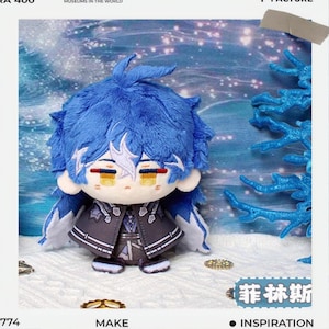 May include: A plush doll with blue hair and a detailed outfit. The doll has a white face with yellow eyes and red accents. The doll is wearing a gray jacket with black and white trim. The background has a winter theme.
