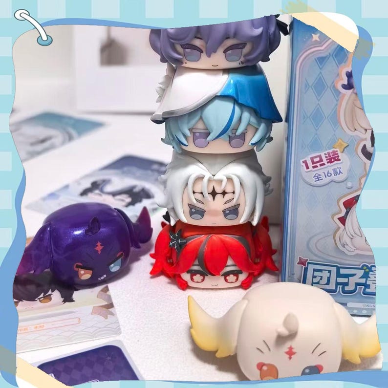 May include: A stack of five chibi-style figurines with colorful hair and outfits. The stack includes figures with purple, white, blue, and red hair. Two additional figurines are also visible, one purple and one cream-colored.