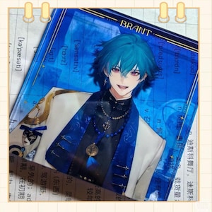 May include: A blue and white illustration of a smiling anime character with blue hair and purple eyes. The character is wearing a dark blue outfit with a white jacket. The background is a blue gradient with text.