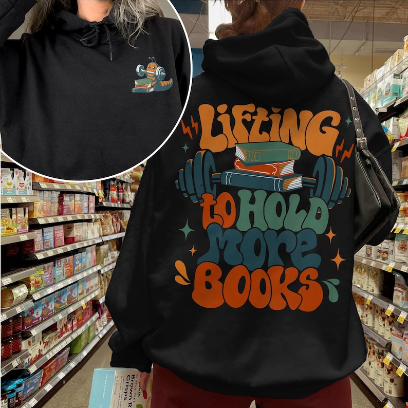 May include: Black hoodie with a graphic of a barbell with books on it and the text "Lifting to hold more books".