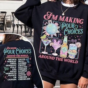 May include: Black sweatshirt with the text "I'M MAKING FOUR CHOICES AROUND THE WORLD" and illustrations of cocktails and a disco ball. The back of the sweatshirt lists greetings from around the world.