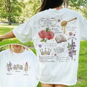 May include: White t-shirt with a floral design and text that reads "Call us even, call me crazy. I don't care, just call me yours."  "Oh darling, I want to call you mine."  "For every girl who has ever felt powerless, we are inevitable. We are tragedy."  "I would spend the rest of my days making her flower crowns if she wanted to be a queen. My queen, not kits, not dyas. Mine."  "For the reckless souls who dare to love and be loved."  "vicious little thing."  "You cannot be nothing when you are everything to someone else."
