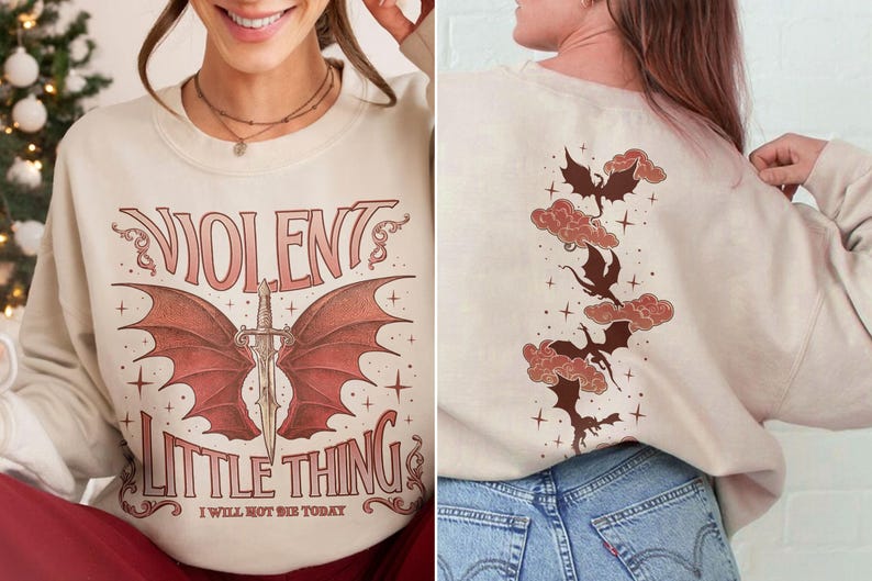 May include: A cream-colored sweatshirt with a graphic print of a red dragon with wings and a sword. The text "VIOLENT LITTLE THING I WILL NOT BE SHE TODAY" is printed below the dragon. The back of the sweatshirt has a graphic print of four red dragons flying in the clouds.
