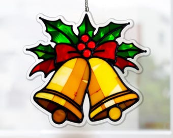 May include: A stained glass Christmas ornament featuring two golden bells with a red bow and green holly leaves. The ornament is outlined in black and hangs from a silver chain. The bells have a textured appearance.