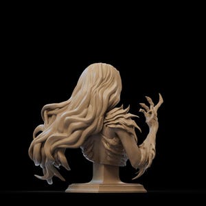 May include: A detailed bust sculpture of a woman with long, flowing hair and a clawed hand reaching up. The sculpture is made of a light brown material and is mounted on a square base.