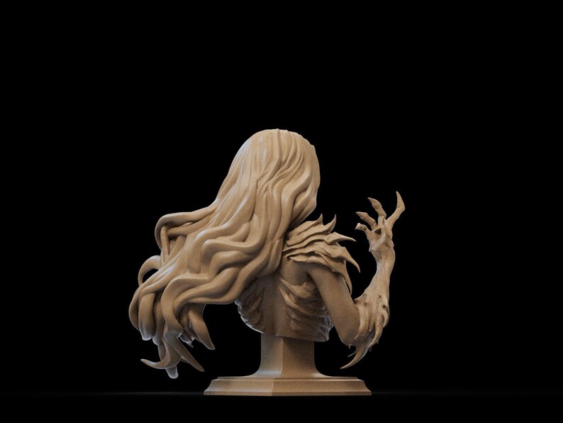 May include: A detailed bust sculpture of a woman with long, flowing hair and a clawed hand reaching up. The sculpture is made of a light brown material and is mounted on a square base.