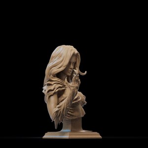 May include: A detailed bust sculpture of a woman with long flowing hair, wearing a feathered garment and holding a small object in her hand. The sculpture is made of a light brown material and is set on a square base.