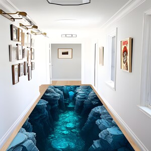 May include: A blue and grey rug with a 3D design of a rocky canyon with a blue water stream running through it.