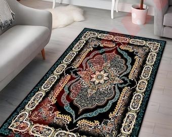 May include: A rectangular area rug with an ornate, floral design. The rug features a black background with a central medallion in shades of red, blue, and gold. The border is a contrasting teal color with repeating floral motifs. The rug is placed on a light-colored wooden floor.
