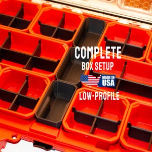 May include: An open, red storage box with multiple compartments and black dividers. The text "COMPLETE BOX SETUP" and "LOW-PROFILE" are displayed, along with a "Made in USA" graphic.