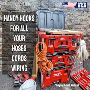May include: A stack of red toolboxes with a black lid open on top. The toolboxes have a silver handle and a silver J-hook on the side. The toolboxes are labeled "Milwaukee Packout". There is a roll of orange cord and a roll of white cord on the side of the toolboxes. The text "HANDY HOOKS FOR ALL YOUR HOSES CORDS WIRING" is on the left side of the image. The text "MADE IN USA" is on the right side of the image.