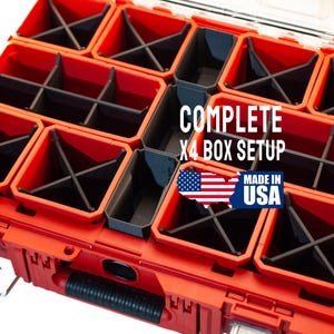 May include: A red and black storage box with multiple compartments. The box is labeled "COMPLETE X4 BOX SETUP" and "MADE IN USA". The compartments are designed to hold various items, with a clear lid.