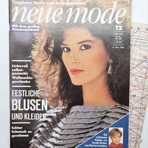 May include: A vintage magazine cover with a woman with dark hair and red lipstick. The magazine title is "neue mode" with German text. The cover also includes the text "FESTLICHE BLUSEN UND KLEIDER" and a small image of a woman.