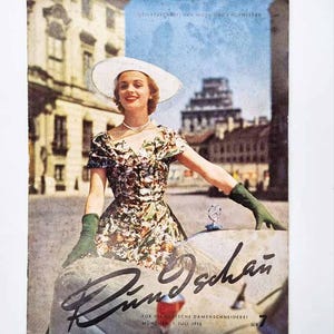 May include: A vintage magazine cover titled Rundschau featuring a person in a floral print dress, white wide-brimmed hat, and dark green gloves leaning against a car. The text reads Monatschrift für Mode und Fachwissen, München, 1. Juli 1955, Nr 7.