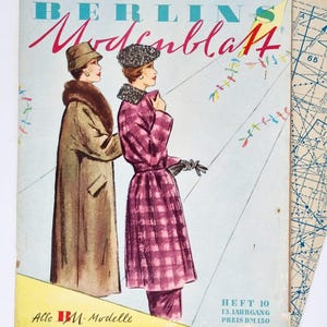 May include: A vintage magazine cover featuring two women wearing stylish coats. The magazine is titled "Berlins Modesiblatt" and the cover features a colourful kite design. The text on the cover reads "Allc BM-Modelle anf 2 Schnittmusterbogen" and "HEFT 10 13. JAHRGANG PREIS DM 150".