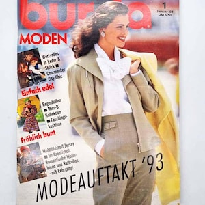 May include: A vintage magazine cover with a woman in a beige suit and white blouse. The cover features the text "BURDA MODEN" in large red letters, with additional text in German. The magazine is dated January '93.