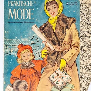 May include: A vintage magazine cover featuring a woman in a yellow scarf and brown fur coat holding a rolled-up piece of paper. A young girl in a red coat and fur hat is standing next to her. The magazine is titled "Praktische Mode" and the text "Sämtliche Modelle auf 2 Schnittbogen" is printed below the title. The magazine cover is set against a blue background with a winter scene.