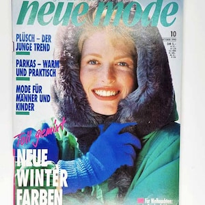 May include: Cover of "Neue Mode" magazine, October 1990 issue. Features a woman wearing a hooded jacket with a fur trim and blue gloves. Text includes "Neue Winter Farben" and "Mode für Männer und Kinder."