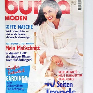 Könnte beinhalten: Titelseite der Zeitschrift "Burda Moden" mit einer lächelnden Frau in Weiß. Deutscher Text beinhaltet "Soft Fabric" und "Mein Schnitt". Die Titelseite erwähnt auch "40 Seiten Trends". Das Heft ist datiert 9/96.