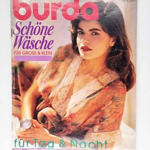 May include: Magazine cover of "Burda Special" with a woman in a floral robe. The title is in pink, with German text below. The cover also includes the text "für Tag & Nacht". The magazine is in German.