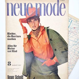 May include: A vintage August 1967 issue of Neue Mode magazine featuring a cover with a person wearing an orange hat, orange shirt, orange gloves, and a green jacket. The text reads: neue mode, Kleider, die Karriere machen, Alles für Mutter und Kind.