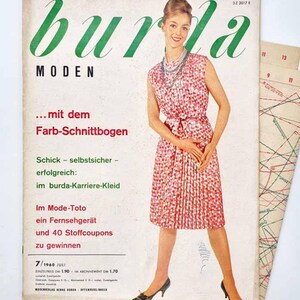 May include: A vintage Burda Moden magazine from July 1960 featuring a cover image of a person wearing a sleeveless, pleated, red and white patterned dress with a matching belt and a multi-strand necklace, alongside printed sewing patterns.