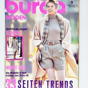 Może przedstawiać: Okładka magazynu modowego w stylu vintage "Burda Moden" z kobietą w beżowym płaszczu, golfie i szortach. Tekst zawiera "33 SEITEN TRENDS" i "Wrzesień '93". Magazyn jest w języku niemieckim.