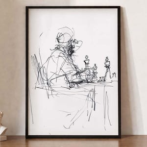 May include: Black and white sketch art print of a person playing chess. The artwork is framed in a black frame and features a minimalist style. The chess pieces are visible on the table.
