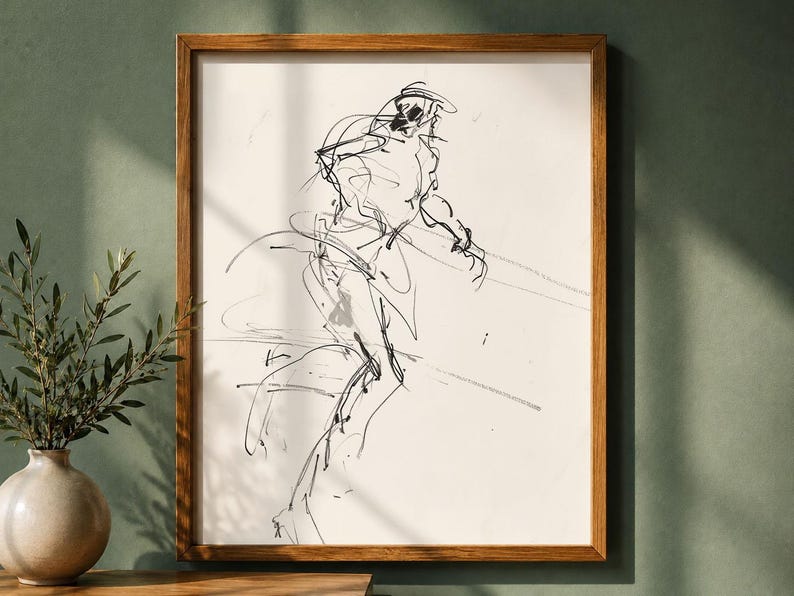 May include: A framed black and white sketch of a person in motion. The artwork is a minimalist line drawing with a wooden frame. The piece is displayed on a wall next to a vase with greenery.