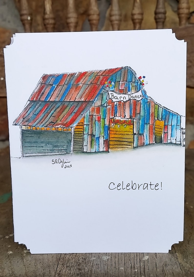 May include: Watercolor illustration of a colorful barn with a red, blue, and orange roof. The barn has a sign that says "Barn Dance" and the word "Celebrate!" is written below. The artwork is on a white card.