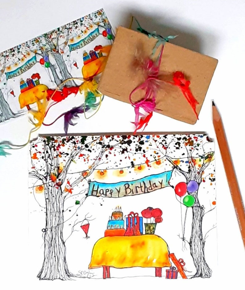 May include: Watercolor birthday cards and a wrapped gift. The cards feature a whimsical illustration of a birthday party scene with a table, cake, and the words "Happy Birthday." The gift is wrapped in brown paper with colorful ribbons.