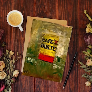 May include: A yellow and red painted canvas with the text "Cafe Buste" on a yellow background. The painting has a textured, abstract style.