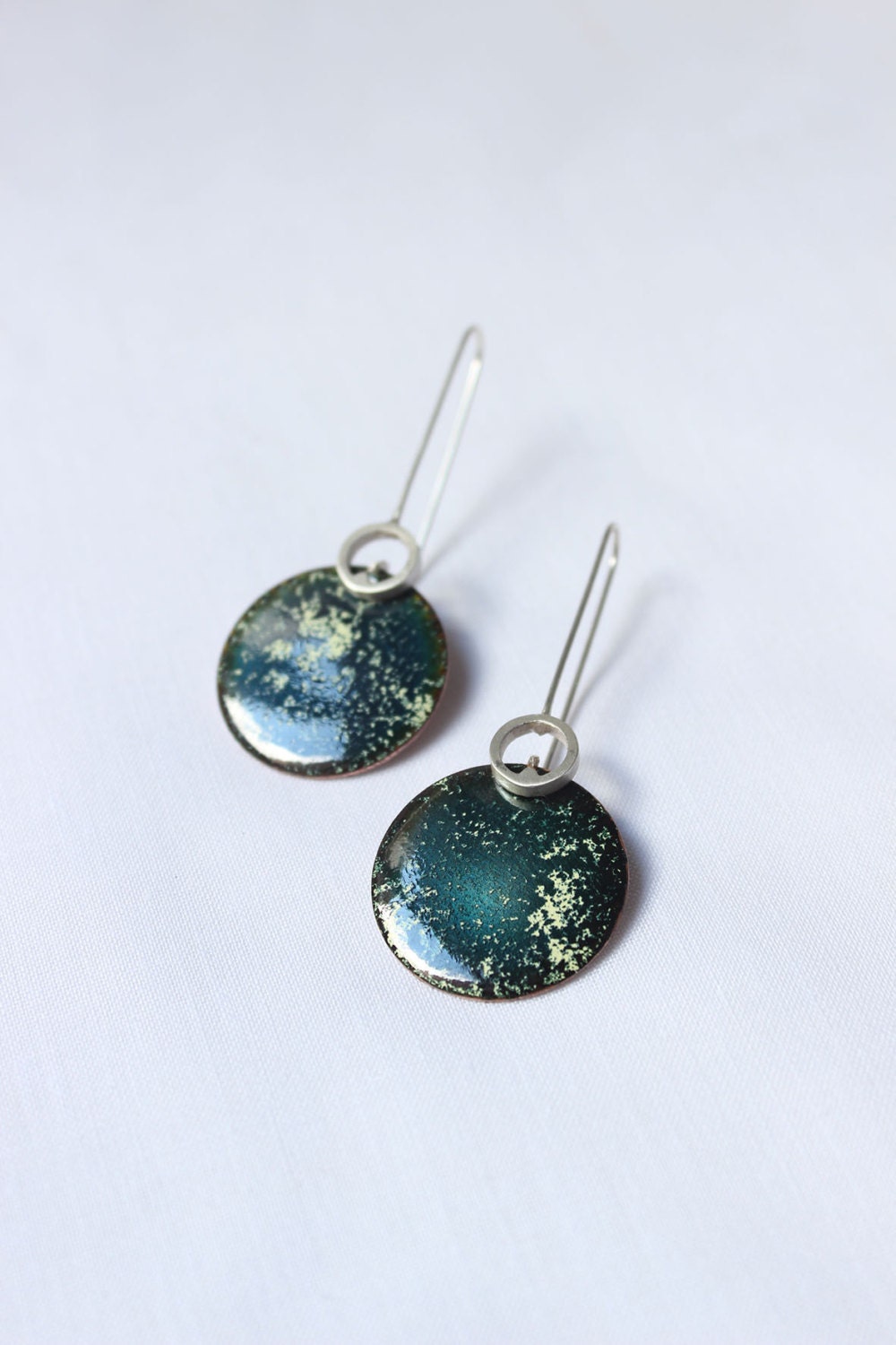 Enameled Incompatibility earrings made of  Sterling silver and copper with green turquoise enamel.