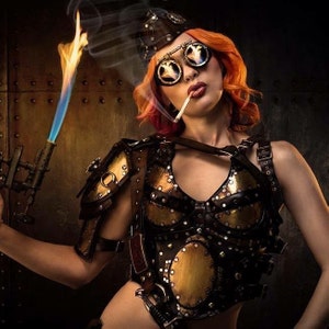 May include: A woman wearing a steampunk-inspired outfit with a gold and brown leather bodice, a cap, and goggles. She is holding a torch in her left hand and a cigarette in her right hand.