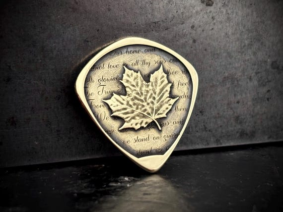 Canadian maple leaf guitar pick solid brass with O Canada lyrics