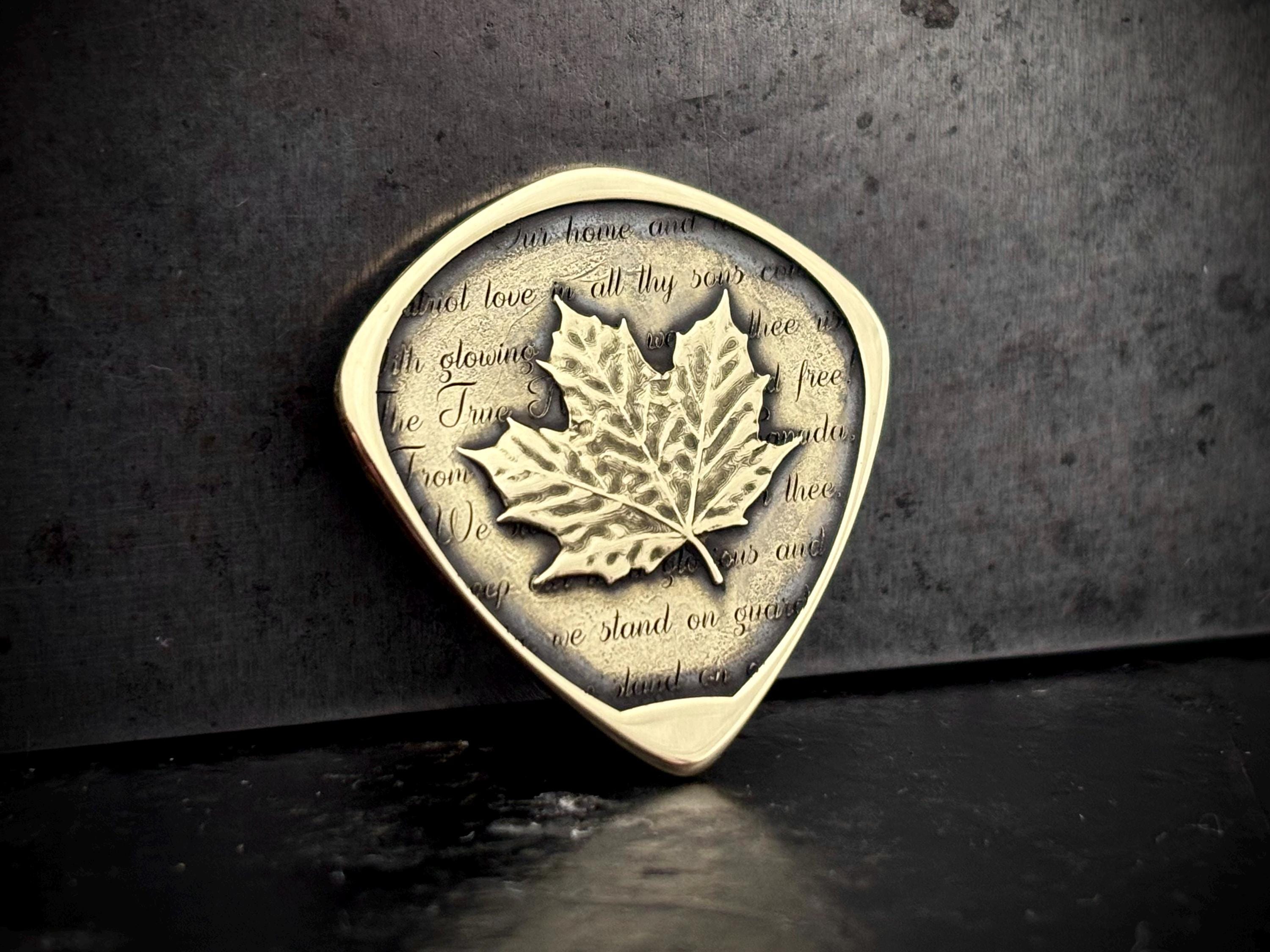 Canadian maple leaf guitar pick solid brass with O Canada lyrics Canadian maple leaf guitar pick solid brass with O Canada lyrics