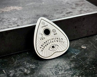 Planchette sterling silver guitar pick made of 925 sterling silver with a ouija design engraved into it
