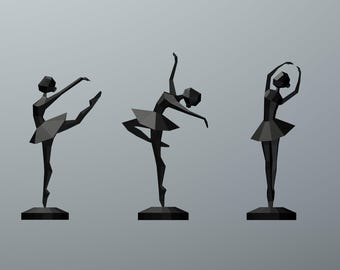 May include: Three black, low-poly geometric figurines of ballet dancers in distinct poses. Each figure features sharp, angular facets and stands on a circular base. The dancers are depicted in motion, with arms and legs extended in various positions.