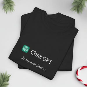 May include: Black t-shirt with a green logo and the text "Chat GPT Is my new Doctor" in white.