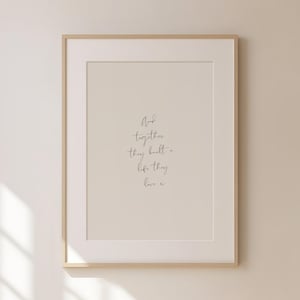 May include: A framed print with the text "And together they built a life they love x" in a simple cursive font.