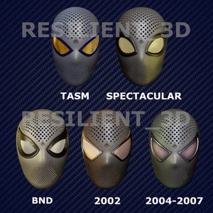 May include: A collection of five gray superhero masks with different eye lens colors and styles. Each mask has a perforated top and the text "TASM", "SPECTACULAR", "BND", "2002", and "2004-2007" below them. The masks are displayed on a dark blue textured background.