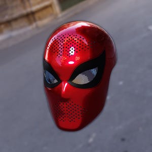 May include: A shiny red full-face mask with black eye coverings and a mesh screen. The mask has small ventilation holes and a number 8 on the top. This mask is likely for cosplay or costume use.