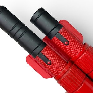 May include: Close-up of two red and black push-up bars. The bars have a textured red grip and black handles. The push-up bars are designed to elevate the user for a deeper range of motion during exercise. The bars are made of metal and plastic.