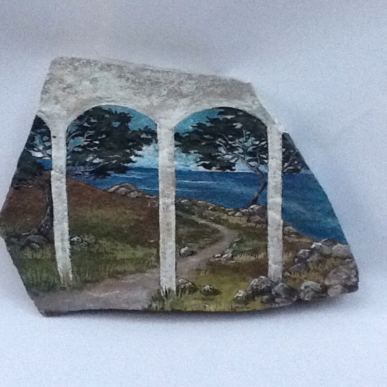 Serene seascape hand painted rock art on flagstone
