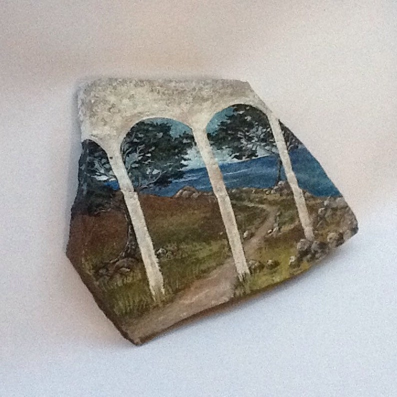 Serene seascape hand painted rock art on flagstone