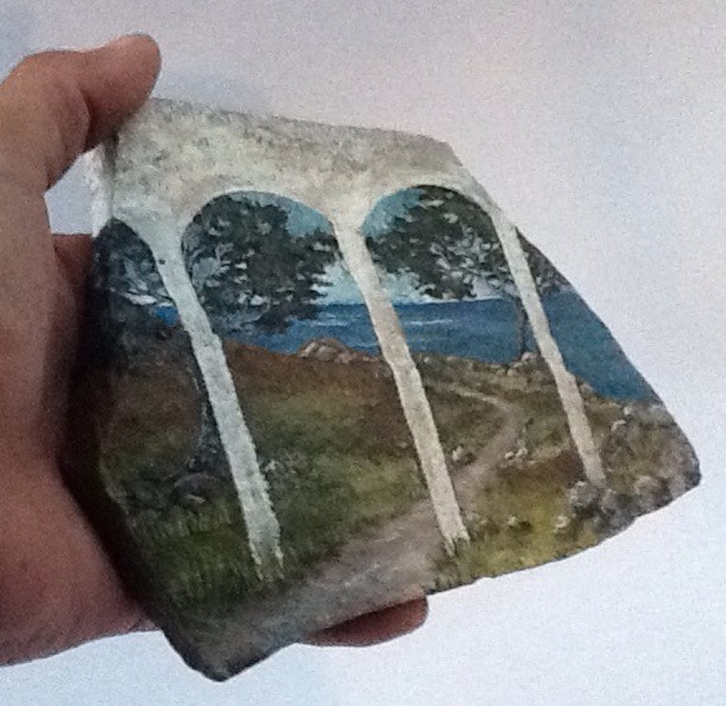 Serene seascape hand painted rock art on flagstone