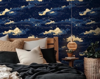 May include: A bedroom scene featuring a navy blue wallpaper with a celestial cloud design in gold and white. The bed has a wooden frame, various pillows, and a dark blue blanket. A woven pendant light and a wicker basket add to the decor.